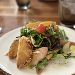 a white plate with a salad on it