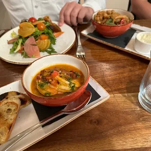 a person sitting at a table with plates of food