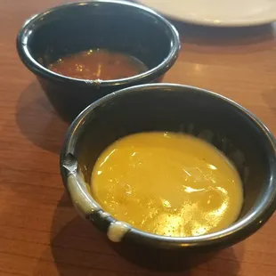 Mostly empty salsa and queso cups. Brought to the table like this.