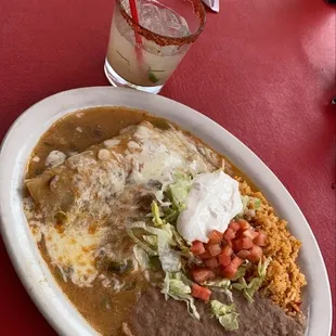 Chicken Enchiladas smothered in green Chile sauce.