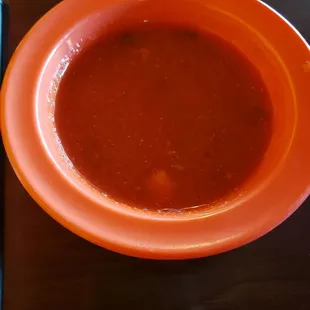 a bowl of soup and a book