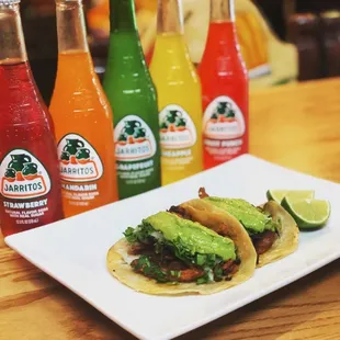 a plate of tacos with guacamole