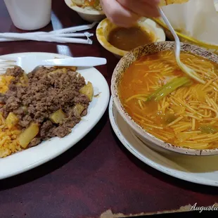 a bowl of soup and a plate of rice