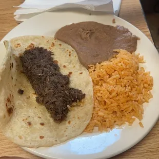 Kids barbacoa taco and rice and beans.