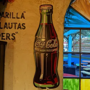 a coca cola bottle on the wall