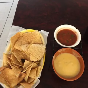 Chips, cheese, and sauce before meal.