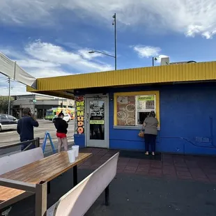 people standing outside of a restaurant