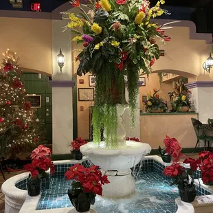 a fountain with flowers in it