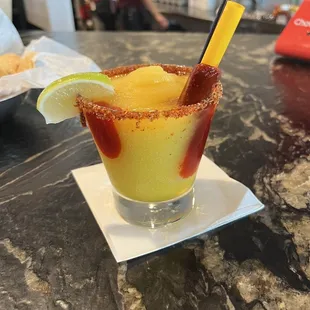 Mango margarita with tahin and chamoy straw. Yum!!
