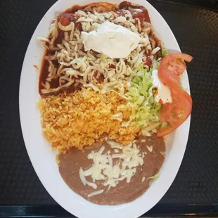 Enchiladas ricas con sus frijoles y arroz y su ensalda y crema encima