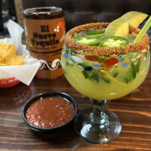 Spicy margarita, salsa and chips and a beer in the background