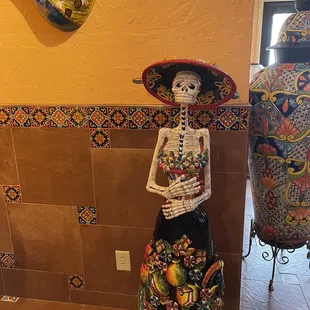 a statue of a woman in a mexican dress