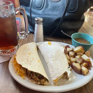 Two huge bacon, egg, and cheese tacos, a side of potatoes, and a giant ice tea!