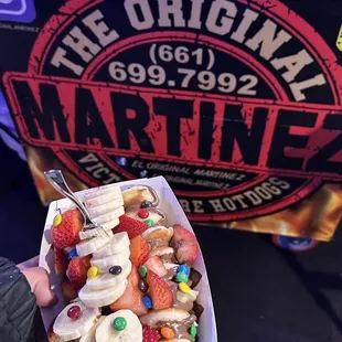 a person holding a plate of fruit