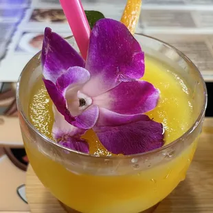 a drink with a purple flower