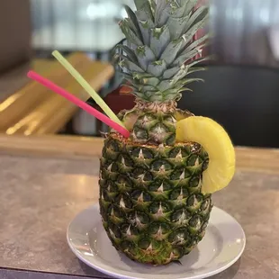 a pineapple with a slice of lemon