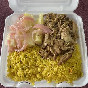 yellow rice, lechon (roast pork), boiled yucca in garlic sauce with red onions