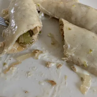 Grilled chicken enchiladas with cheese sauce on top (no tomato).