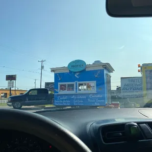 a blue food truck on the road