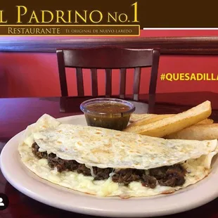 a plate of quesadilla and french fries
