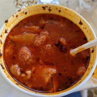 a bowl of soup with a spoon in it