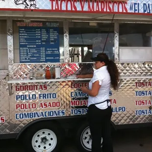 a woman ordering food from a food truck