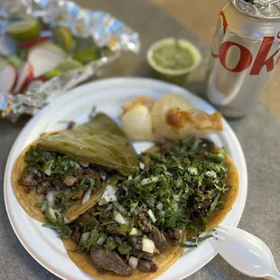 a plate of food and a can of coke