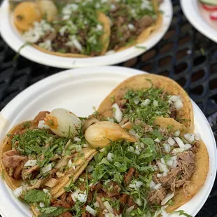 Al pastor, carnitas, tripa (front) Carne asada tacos (back)