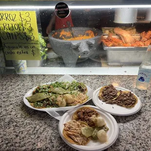 three plates of food on a counter
