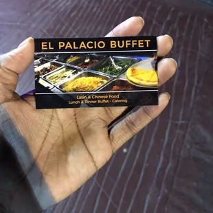 a hand holding a box of food