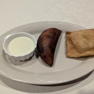 One empanada (looks burned but it was not)  and a Pastie