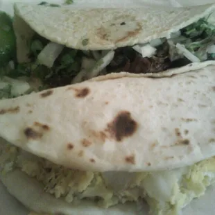 Delicious Barbacoa taco w/ cilantro and onions on corn tortilla and a big potato and a egg taco! :)