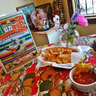 a bowl of chips and a bowl of salsa