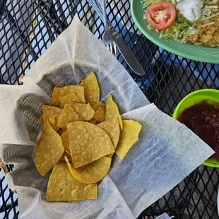 a plate of chips and a bowl of salsa