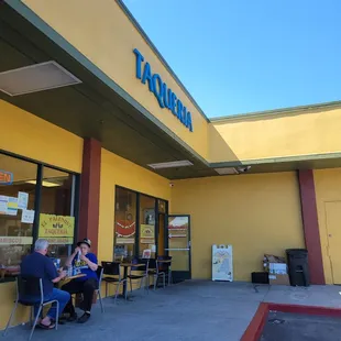 people sitting at tables outside