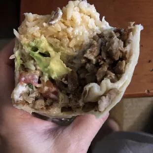 Biting into a beef burrito