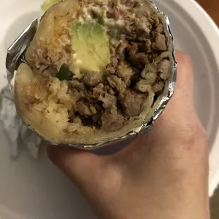 Cutting into a carne asada super burrito