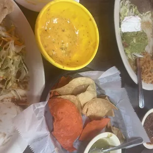 Green enchilada plate, queso and chips and Mexican plate