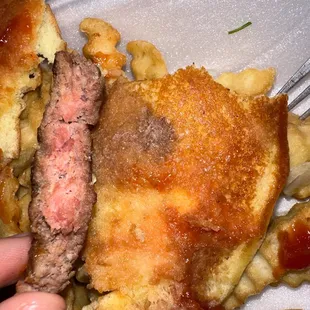 a hand holding a piece of food