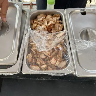 a hand grabbing a container of food