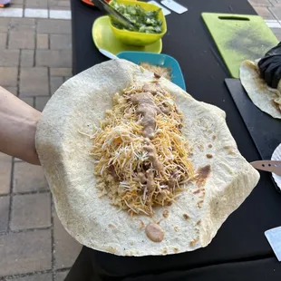 a person holding a tortilla