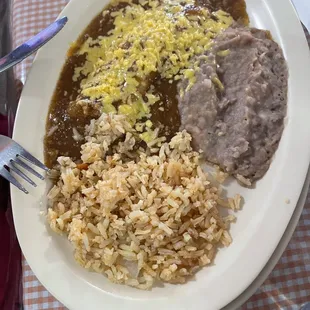 A la carte plate for one child- cheese enchilada, rice, and beans.