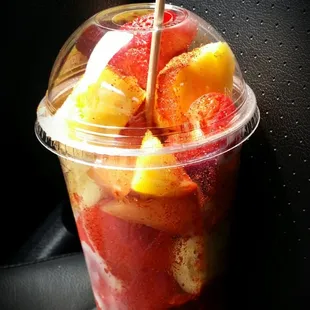 a plastic cup filled with fruit