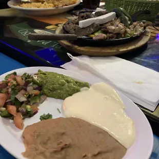Beans, crema, picante and guac! Background: fajita plate!