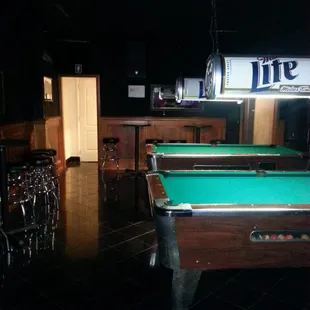 two pool tables and a bar