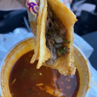 birria taco dipped in consome
