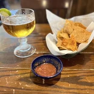 The table was a little beat up , but the chips and salsa was good .