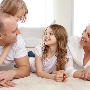 a family laying on the floor