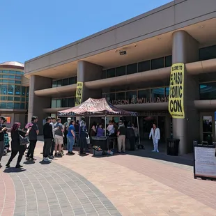 a crowd of people standing in front of a building