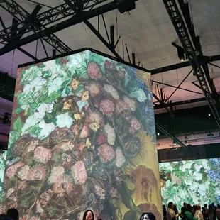 a woman standing in front of a painting